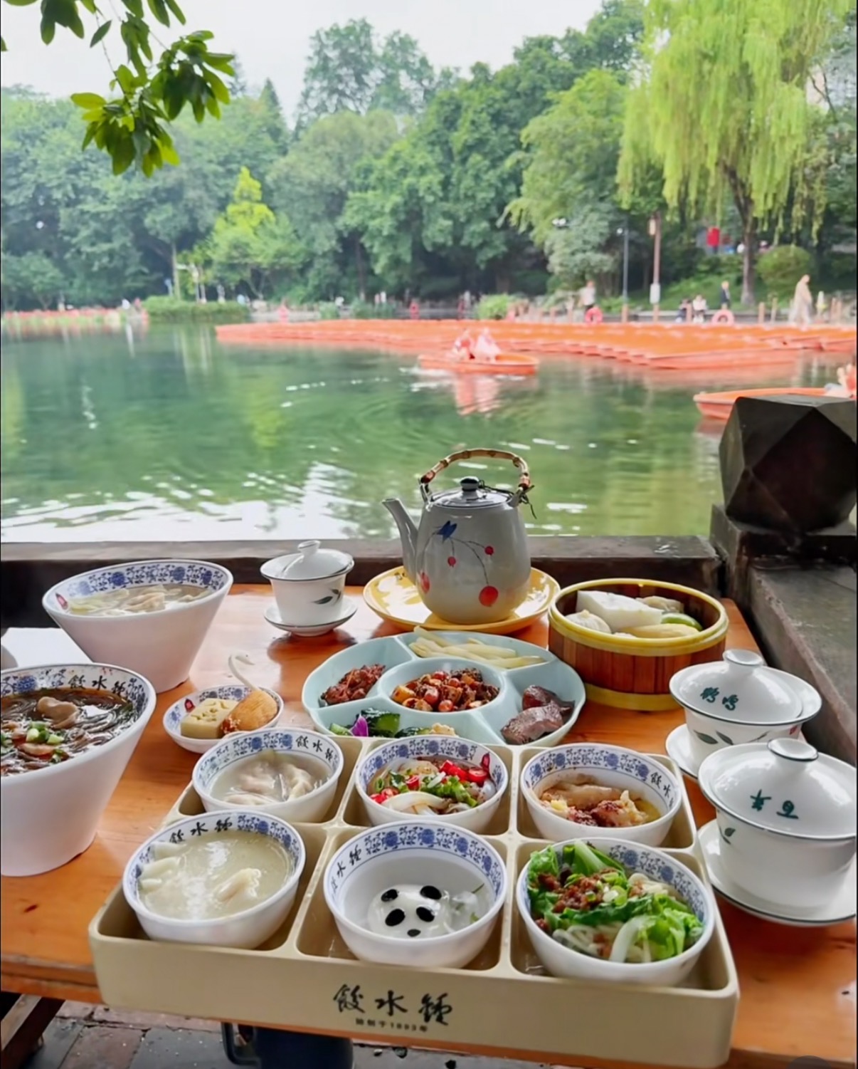 Tea and local dishes beside the water at a Chengdu teahouse